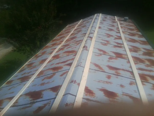 Rusted metal roof panels with new wood purlins before replacement — Storm Damage Roof Repair in Fountain Green by Roofing Brothers